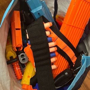 A full bag of Nerf guns and gear.